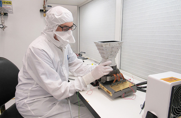 Engineer (APL) installs wide-angle camera detector electronics on a test model of the imaging system (NASA / APL / Ed Whitman)