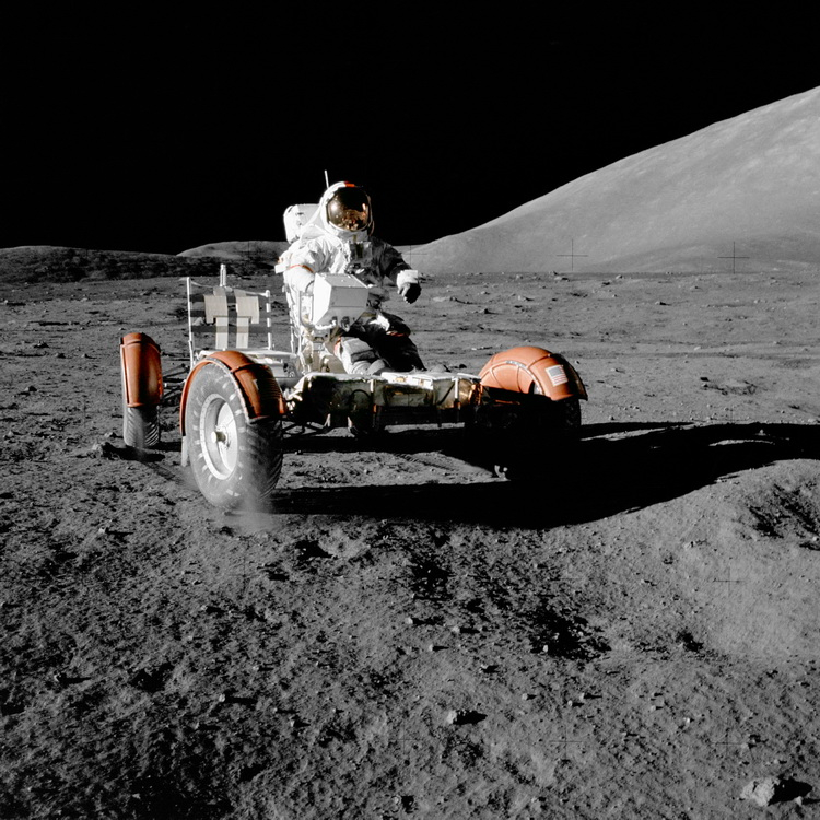 Eugene Cernan rides a lunar car through the bumpy lunar valley of the Taurus-Littrow